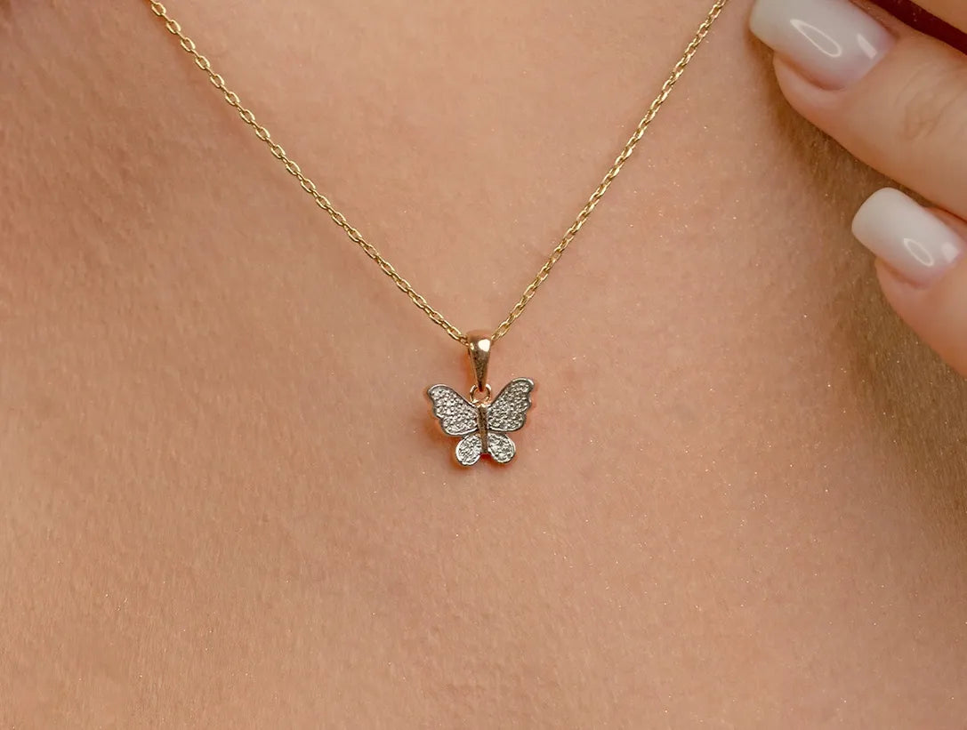 Gold butterfly pendant necklace styled for different outfits and occasions